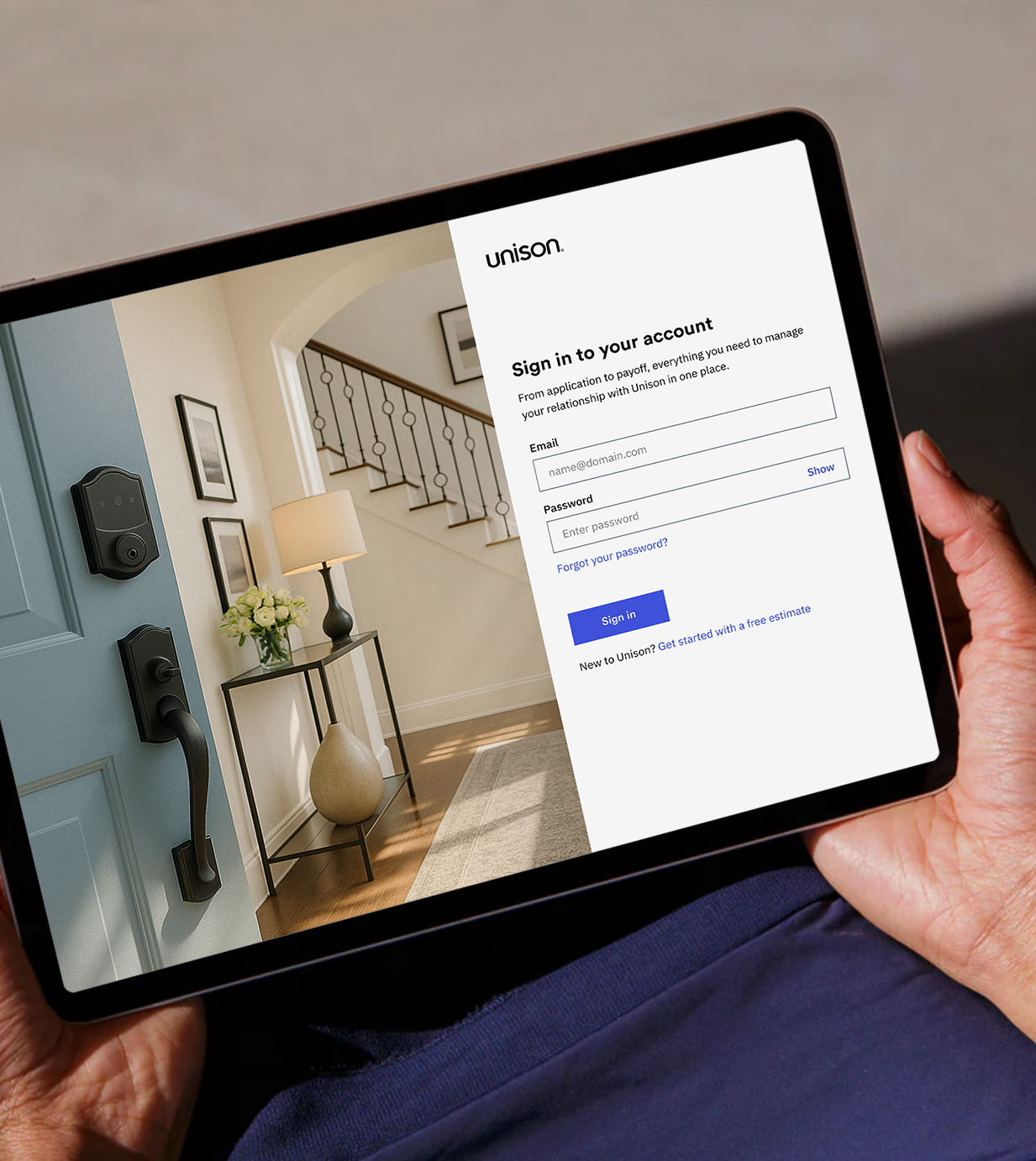Tablet showing the Unison account sign-in screen next to a photo of a home entryway.